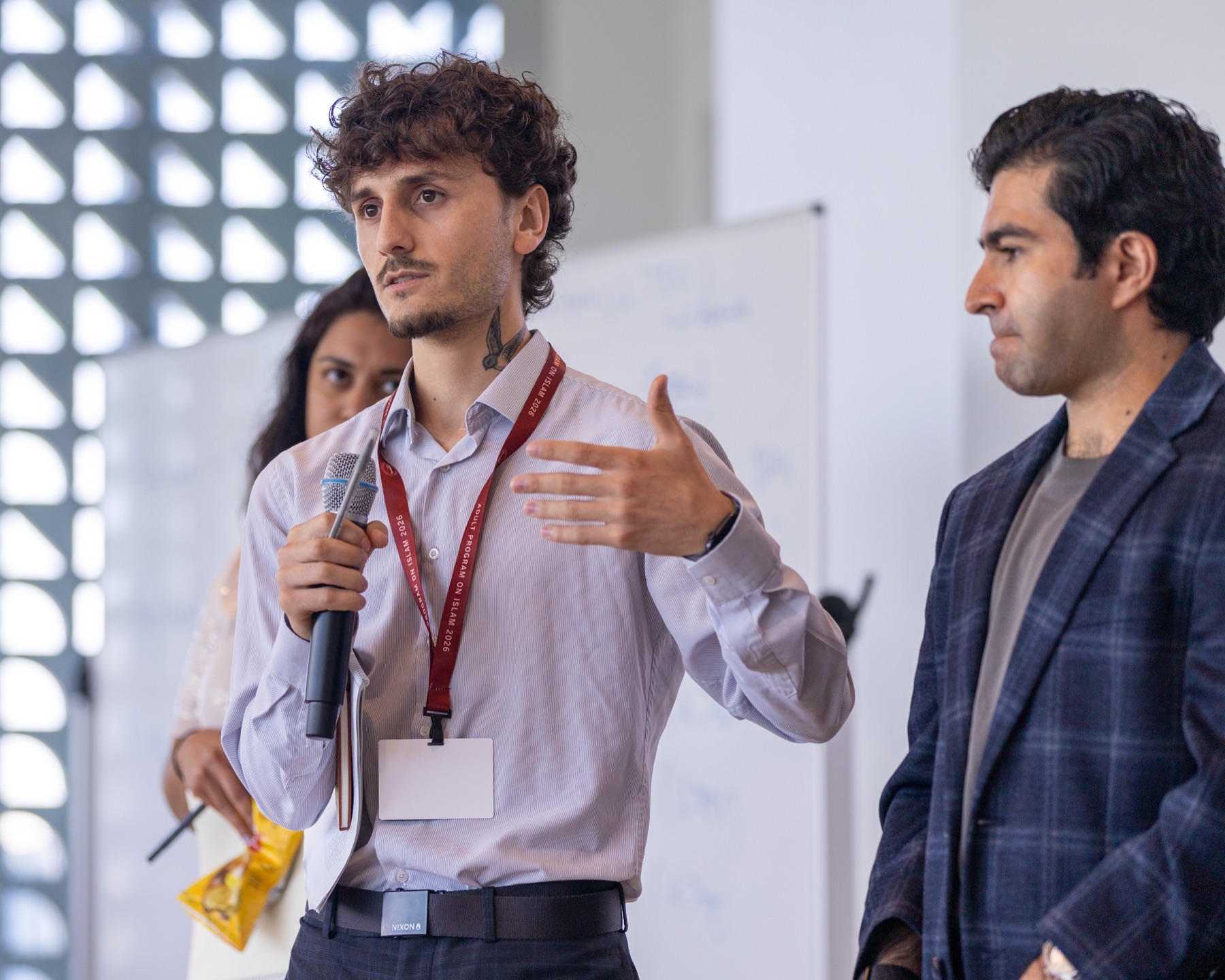 A participant presenting to the group with a microphone.